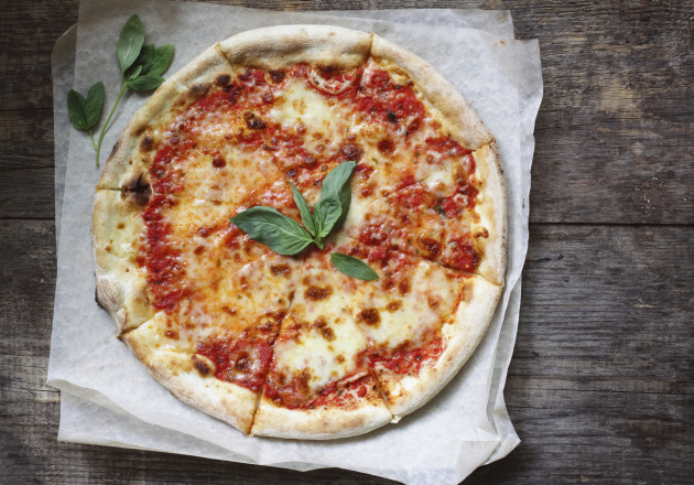 According to legend, the traditional Marghareta pizza was named after Queen Marghareta of Savoy on a visit to Naples. The tomato sauce, mozerella, and basil represent the red, white, and green of the Italian flag.
					
