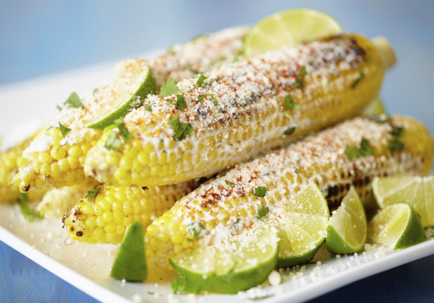 A popular Mexican street food is called elote, which is corn on the cob served on a stick. The corn is rolled in mayonnaise and smothered with cheese, lime, chili powder, and salt.
					